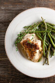 Chicken with gravy, thyme and green asparagus (top view)
