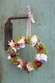 Wreath of peonies, sweet peas and ladies' mantel hung from vintage door handle