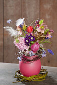 Spring flowers in pink wax vase