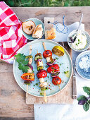 Grilled vegetable skewers with haloumi and baguette with crème fraîche and olive oil