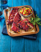 Baby back ribs in plum sauce with stone fruit slaw