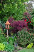 Bird feeder in a landscaped garden