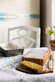 Pistachio loaf cake with a lime glaze on a table