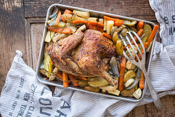 Roast chicken on a bed of oven-roasted vegetables