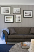 Gallery of black-and-white photos above grey sofa