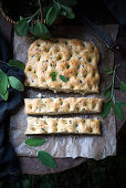 Vegan focaccia with sage and olives (seen from above)