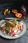 Vegetable salad with blood oranges and pomegranate seeds