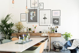 White dining table, shell chairs and rustic workbench in dining room