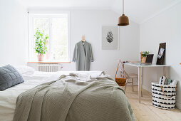 Bright, Scandinavian-style bedroom with desk