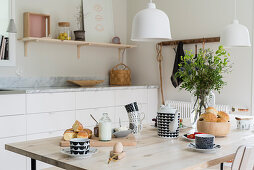 Casually set breakfast table in Scandinavian-style kitchen-dining room