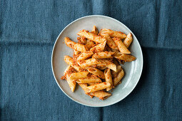 Penne with red autumnal pesto made from hazelnuts and tomatoes