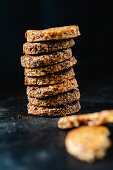 A stack of spiced biscuits with walnuts, dates and coconut flakes