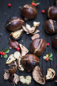 Roasted chestnuts displayed on the wooden table ready for cleaning and eating