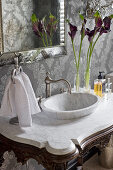 Modern marble sink on antique washstand