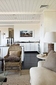 View from living room in shades of brown into open-plan kitchen