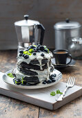 Charcoal pancakes with blueberries and vegan soy cream