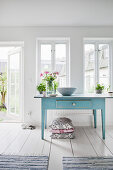 Old blue table, lattice windows and door leading into garden