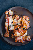 Fried bacon on wooden plate
