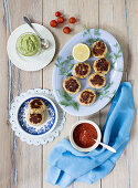 Crab cakes with tomato sauce and avocado dip