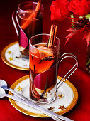 Hot Spiced Cider with cinnamon sticks orange wedgges and cloves