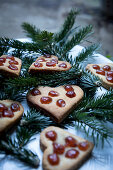 Gingerbread Christmas heart biscuits decorated with glace cherries