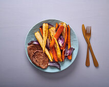 Lamb steaks with roasted carrots, parsnips & red onion