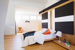 Diptych with cross motif above the bed in the simple bedroom