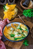 Zucchini flowers stuffed with herbs and cream cheese and baked