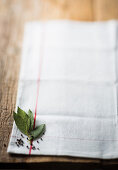 Peppercorns and bay leaves on a white tea towel