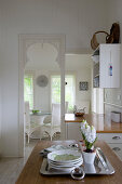 Open doorway and serving hatch between kitchen and dining room