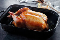 Roast chicken with honey in a black dish