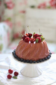 A Bundt cake with cherries and berries
