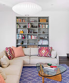 Beige corner sofa in front of a bookcase in the living room