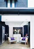 View of two armchairs in the kitchen through an open patio door