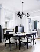 Upholstered chairs around oval dining table in elegant gray dining room