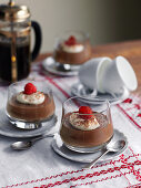 Chocolate pudding with cream and raspberries