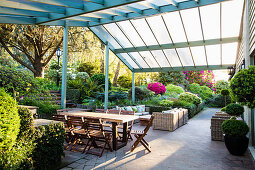 Dining table with chairs and lounge furniture on the covered terrace