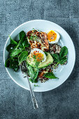 A breakfast bowl with quinoa, spinach and halloumi