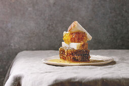 Organic honey in honeycombs with slices of wheat bread in spotted ceramic plate