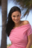 A young brunette woman wearing a red-and-white striped top