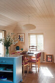 Marble-topped base unit painted blue in open-plan kitchen-dining room