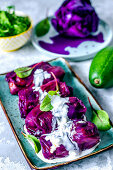 Stuffed purple cabbage with minced meat and rice, avocado and boiled cabbage
