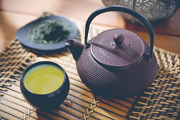 Green tea in a pot and a mug
