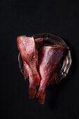 Raw frozen uncooked fish perch on black background