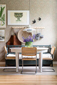 Cantilever chairs with cane seats and backrests at dining table with rustic wooden bench