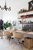 Two swivel chairs at desk with sewing machine and vintage accessories