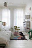 White bedroom in period building decorated with retro furniture