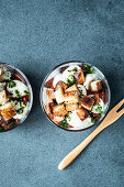 Caprese salad with croutons in glasses