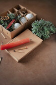 Speckled eggs, chickweed, matches and candle in egg box