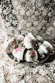 Vintage cups with floral motifs on plate